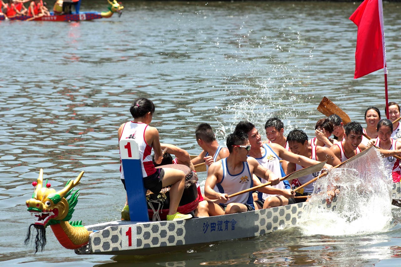 Dynamic dragon boat race with energetic rowers on Shing Mun River, Hong Kong.